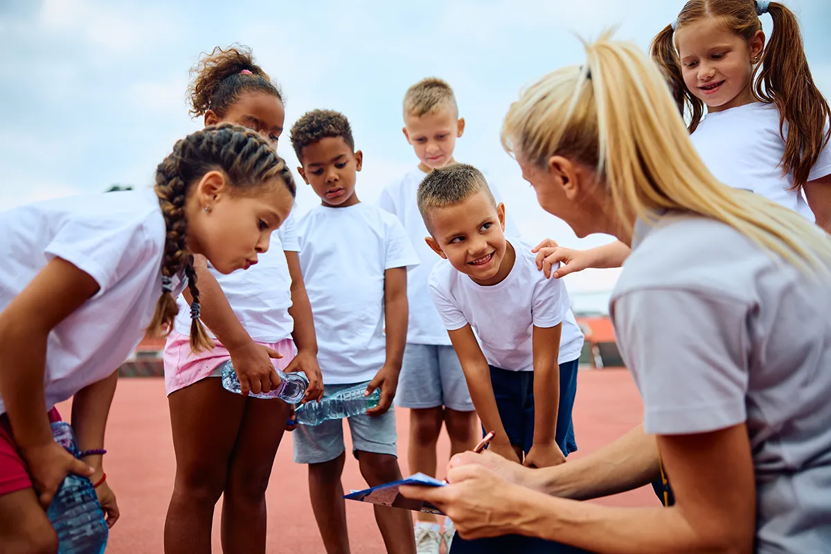 Summer camp counselor reviews camper safety expectations at a youth summer camp.