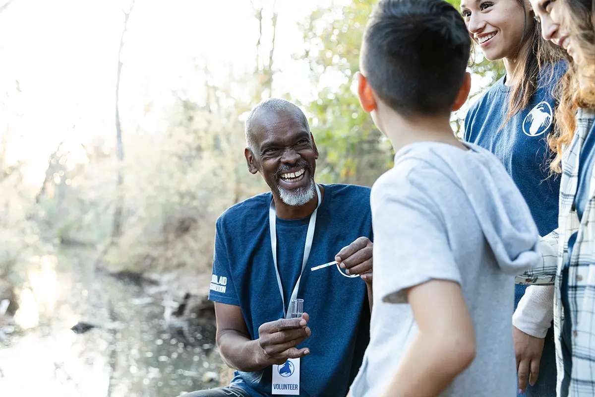 A group of volunteers and students participating in an outdoor science project.